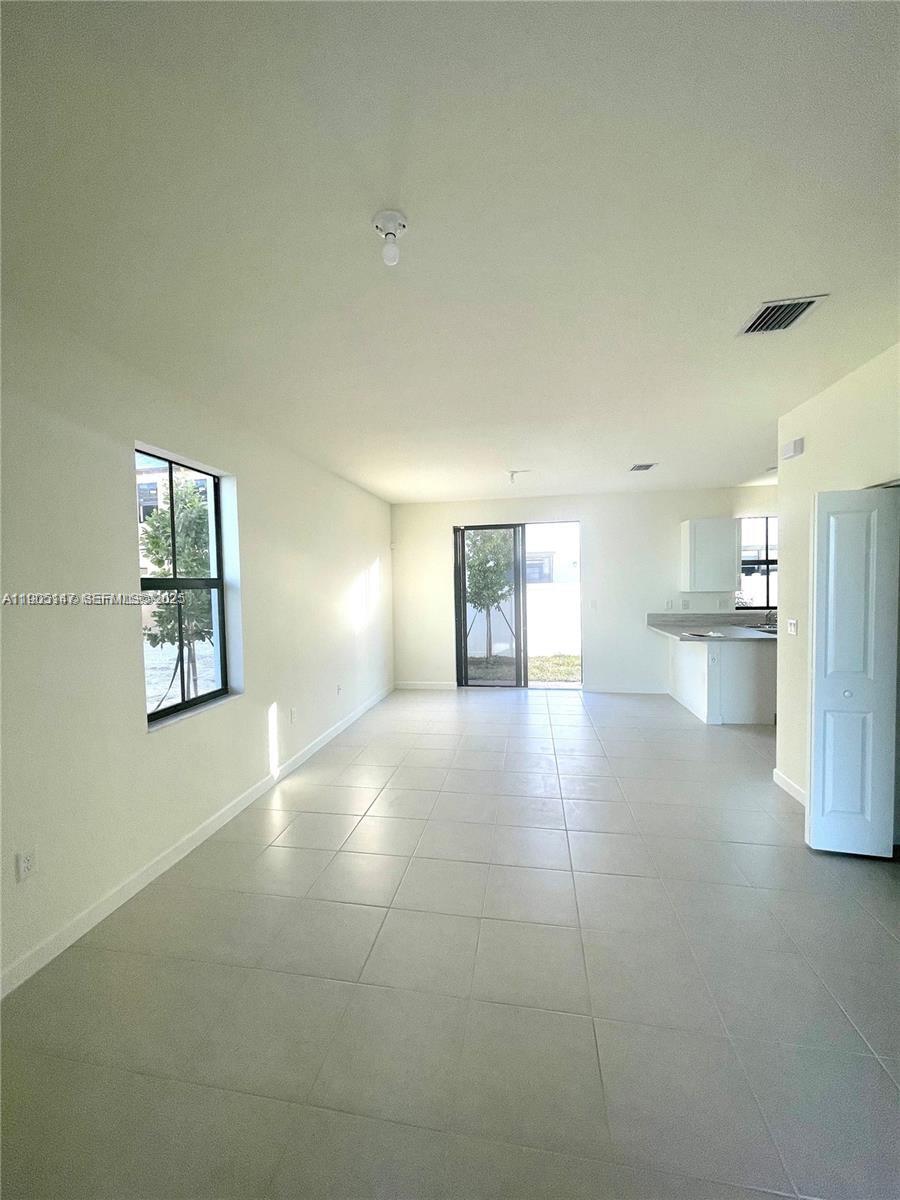 3338 West 112th Street Hialeah, FL 33018 - Photo 6 of 40 a view of an empty room with a window