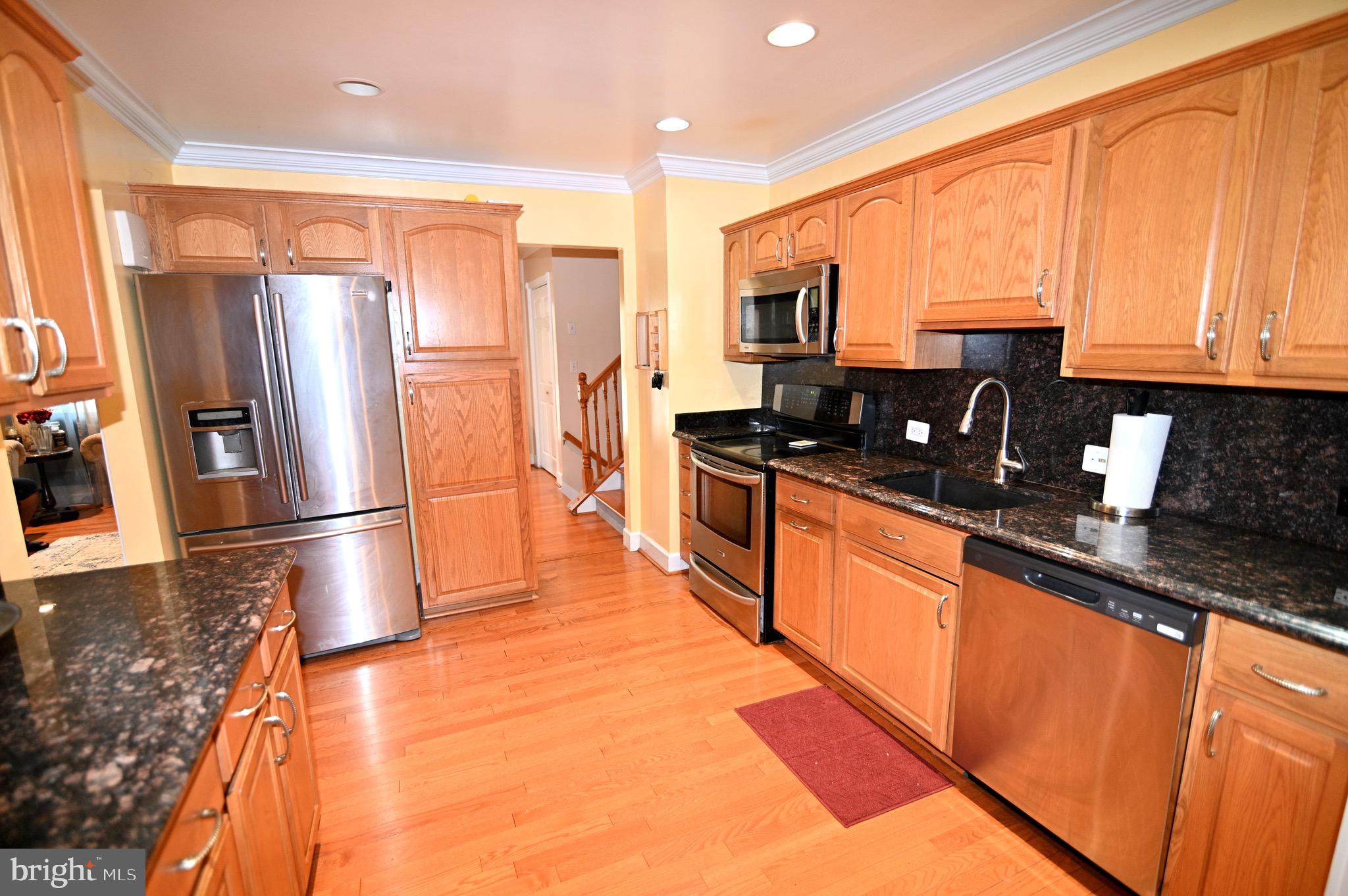 3407 Wayneswood Road Fort Washington, MD 20744 - Photo 11 of 70 a kitchen with stainless steel appliances a refrigerator sink and stove
