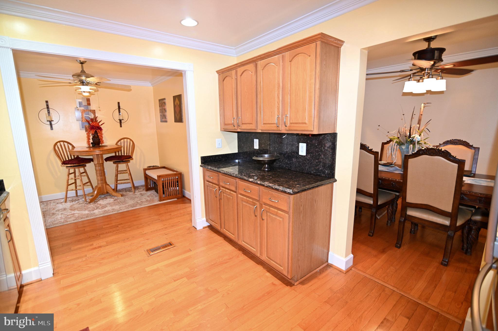 3407 Wayneswood Road Fort Washington, MD 20744 - Photo 12 of 70 a open kitchen with stainless steel appliances granite countertop a stove a sink a dining table and chairs with wooden floor