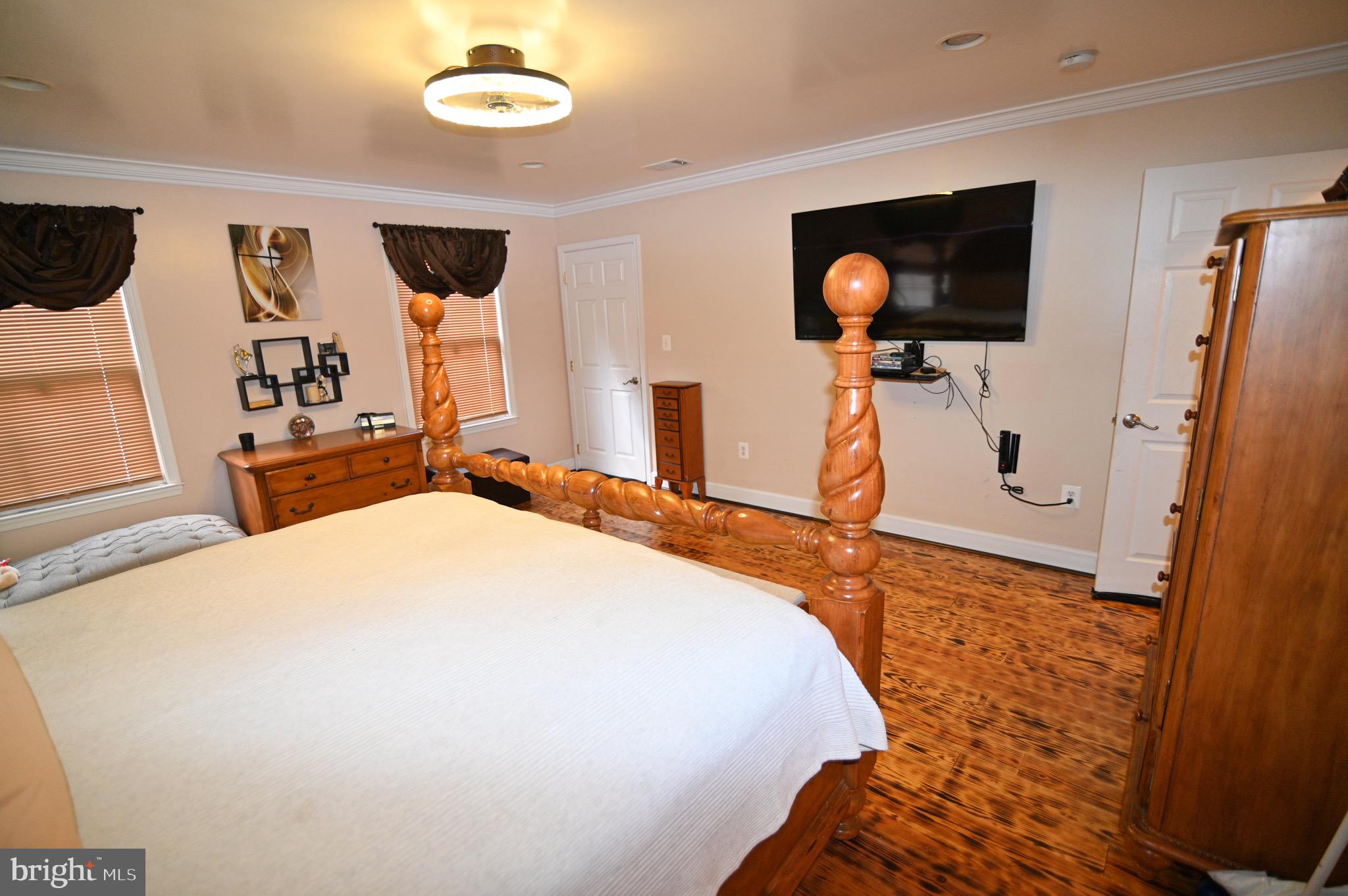 3407 Wayneswood Road Fort Washington, MD 20744 - Photo 19 of 70 a bedroom with a bed and a flat tv screen on dresser
