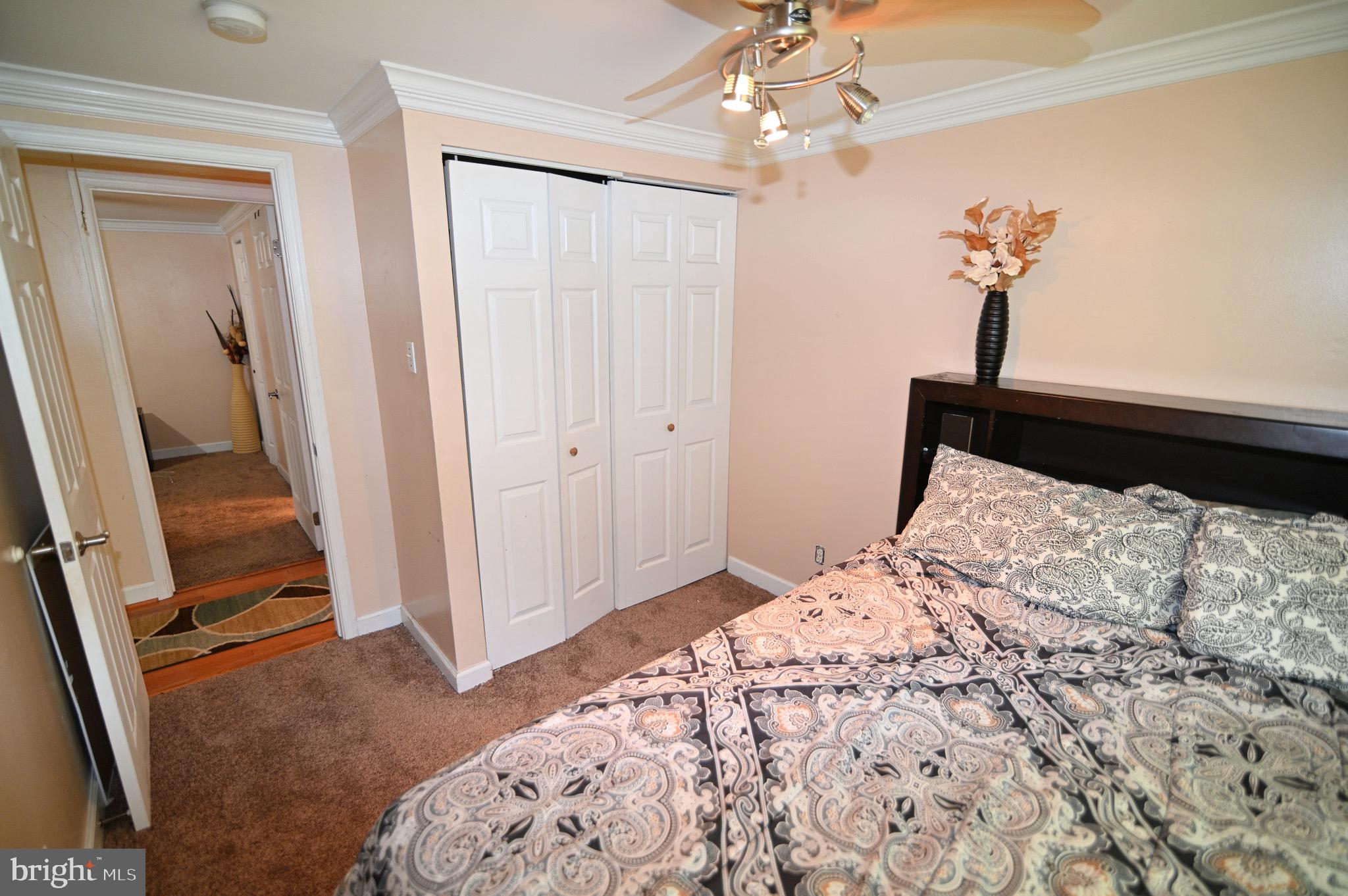 3407 Wayneswood Road Fort Washington, MD 20744 - Photo 28 of 70 a bedroom with a bed and a chandelier fan