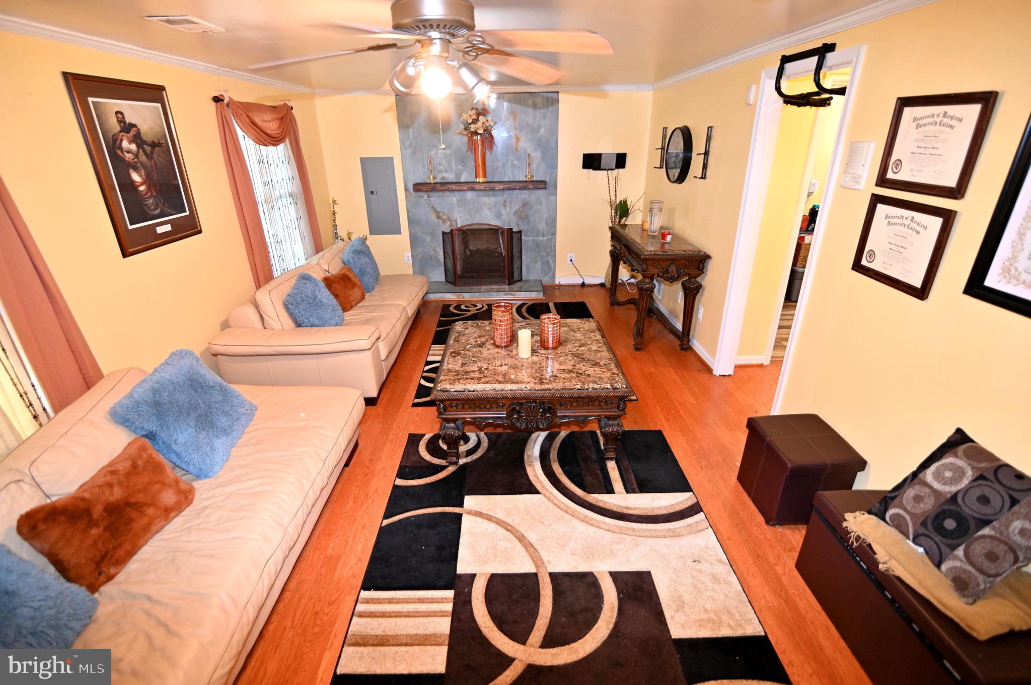 3407 Wayneswood Road Fort Washington, MD 20744 - Photo 51 of 70 a living room with furniture and a fireplace