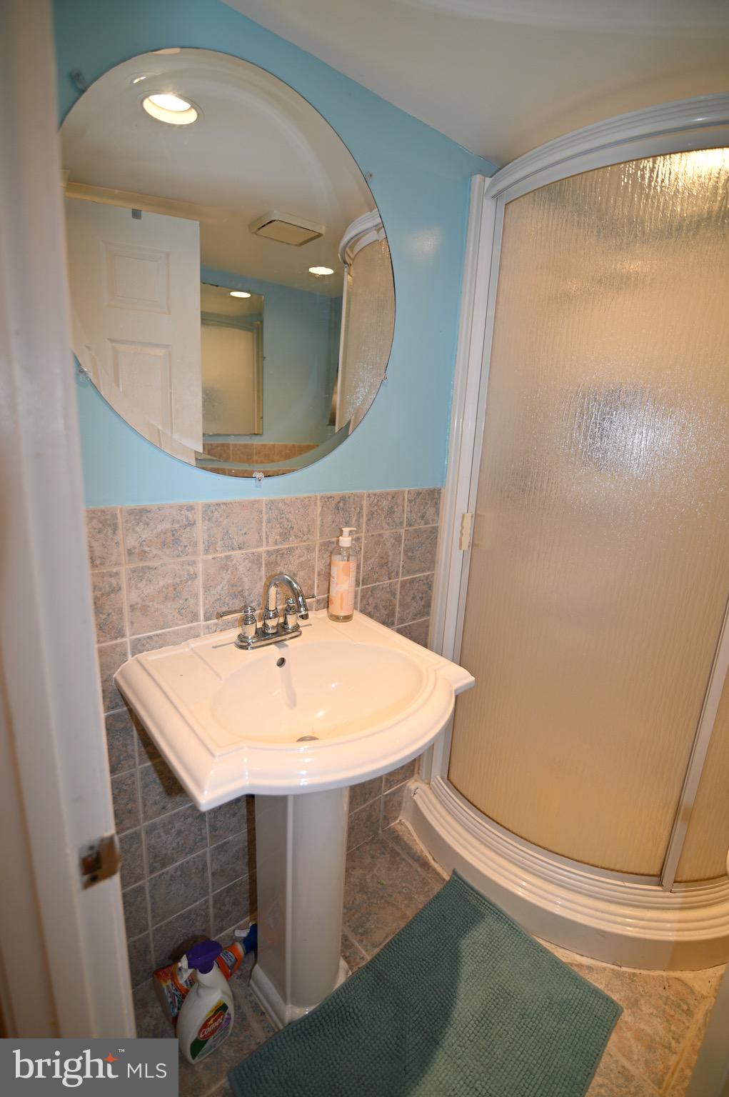 3407 Wayneswood Road Fort Washington, MD 20744 - Photo 53 of 70 a bathroom with a sink a mirror and a toilet