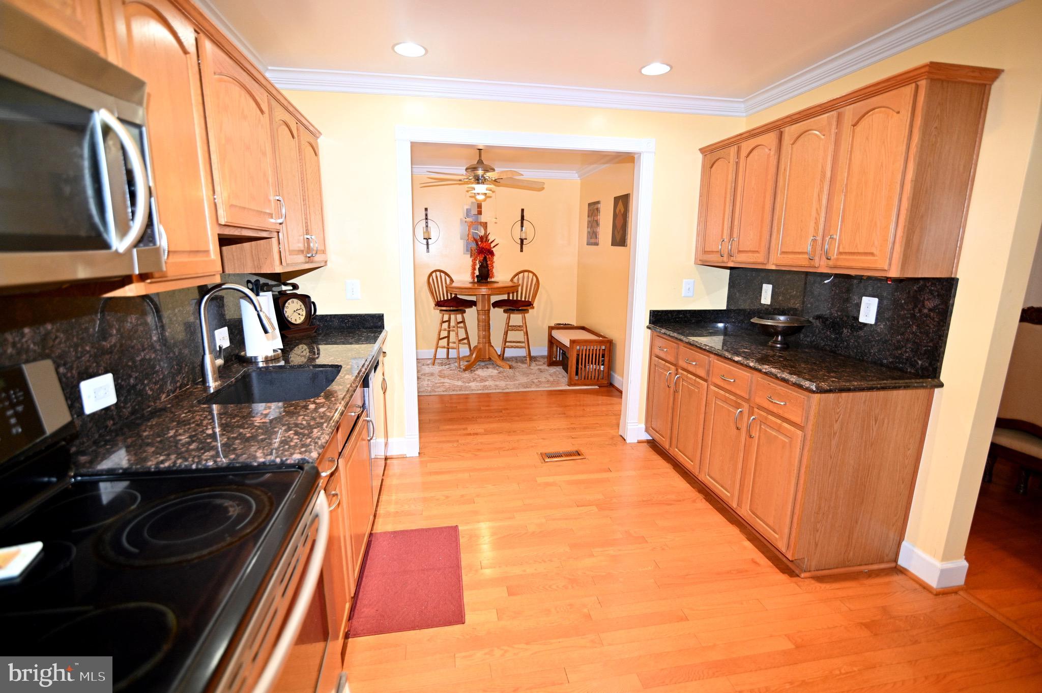 3407 Wayneswood Road Fort Washington, MD 20744 - Photo 10 of 70 a kitchen with stainless steel appliances granite countertop a stove a sink and a microwave