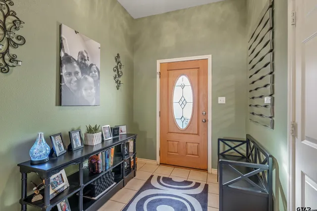 a room with furniture a rug and a window