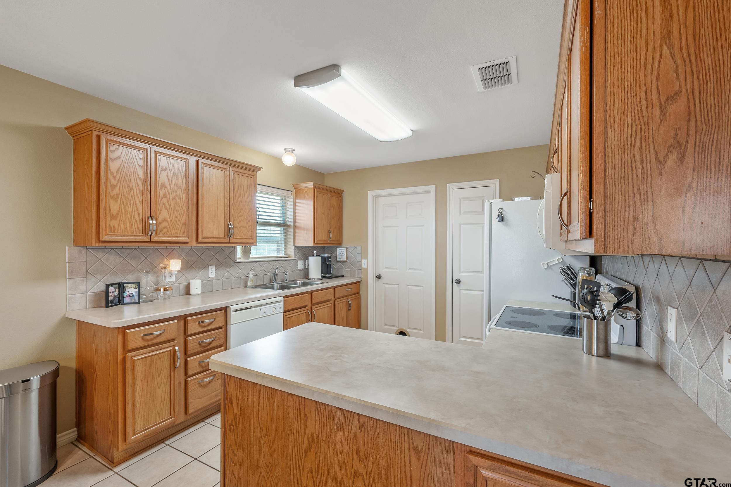 20081 Bluegrass Circle Flint, TX 75762 - Photo 22 of 24 a kitchen with a sink stove and cabinets