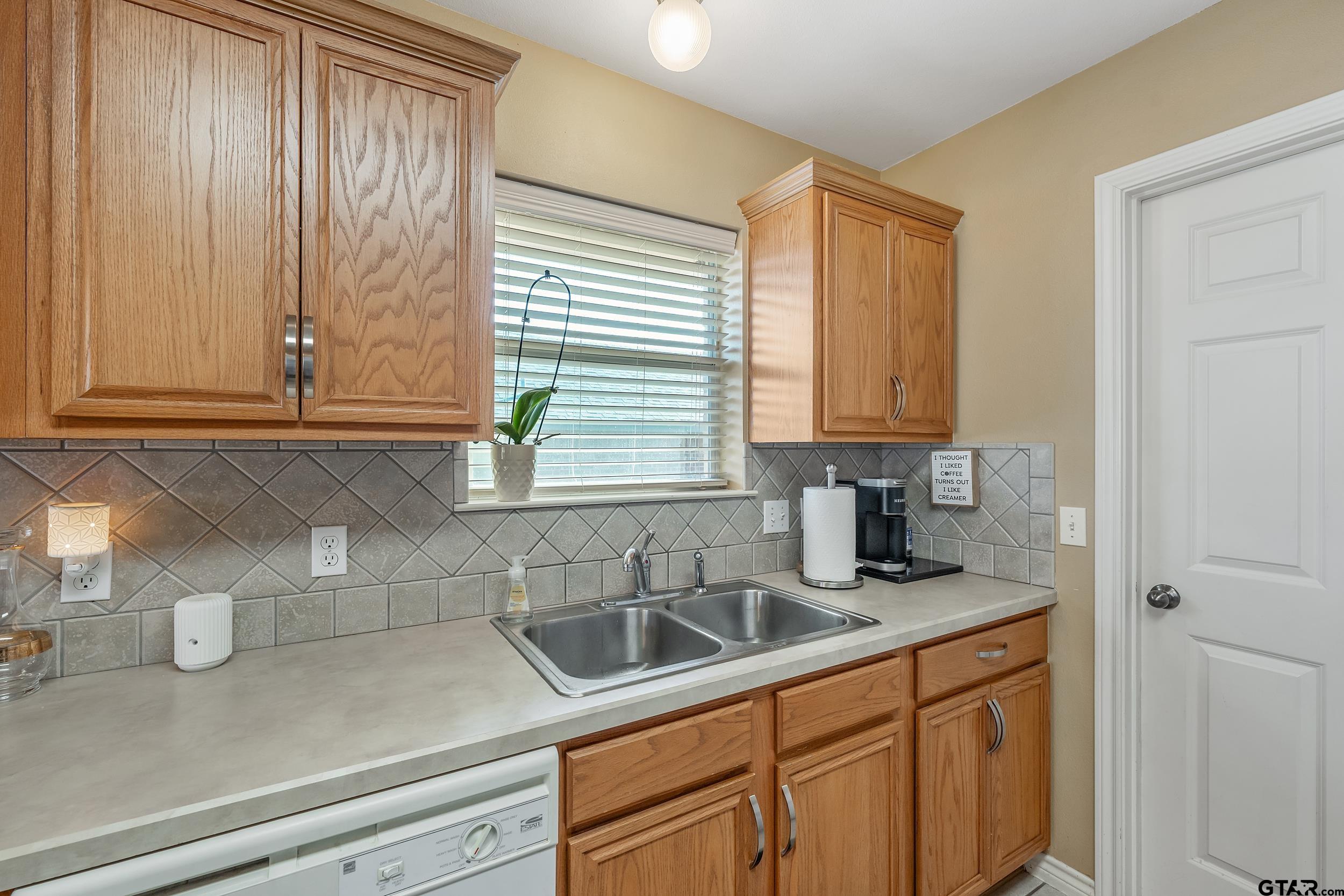 20081 Bluegrass Circle Flint, TX 75762 - Photo 23 of 24 a kitchen with stainless steel appliances white cabinets and a window