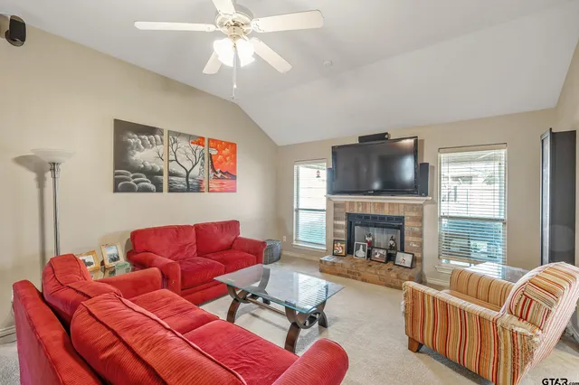 a living room with furniture fireplace and flat screen tv