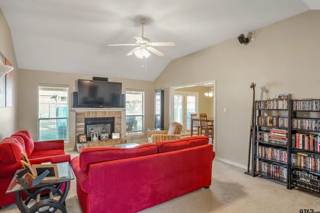 a living room with furniture a fireplace and a flat screen tv