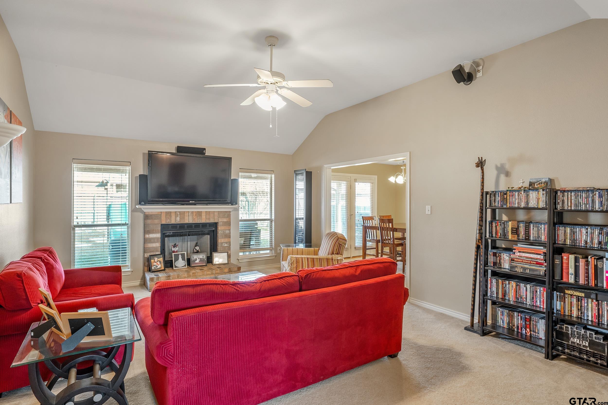 20081 Bluegrass Circle Flint, TX 75762 - Photo 4 of 24 a living room with furniture a fireplace and a flat screen tv