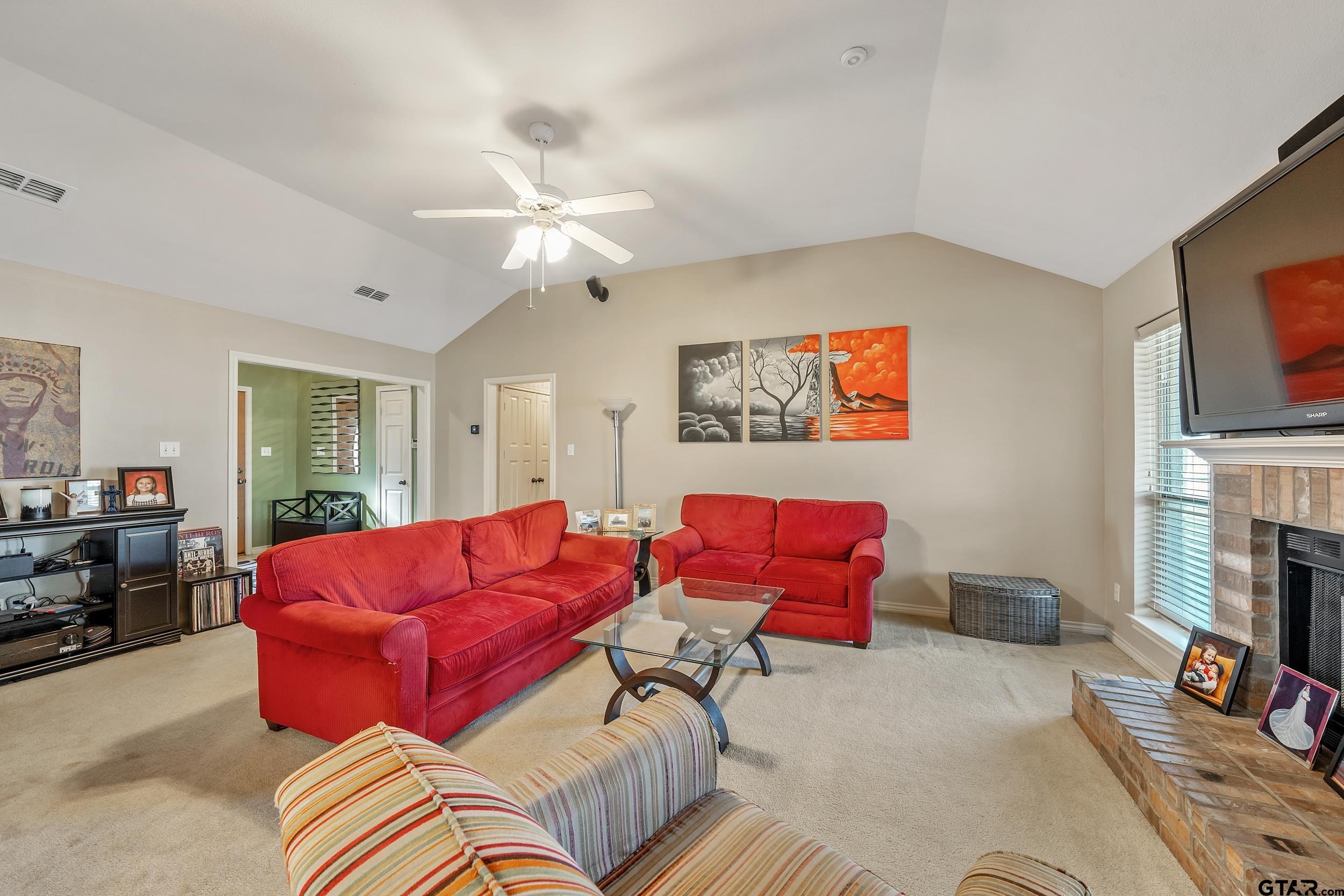 20081 Bluegrass Circle Flint, TX 75762 - Photo 5 of 24 a living room with furniture a flat screen tv and a fireplace