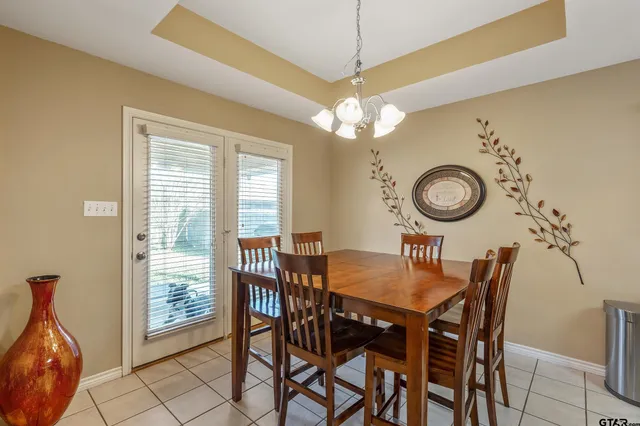 a view of a dining room and a chandelier fan