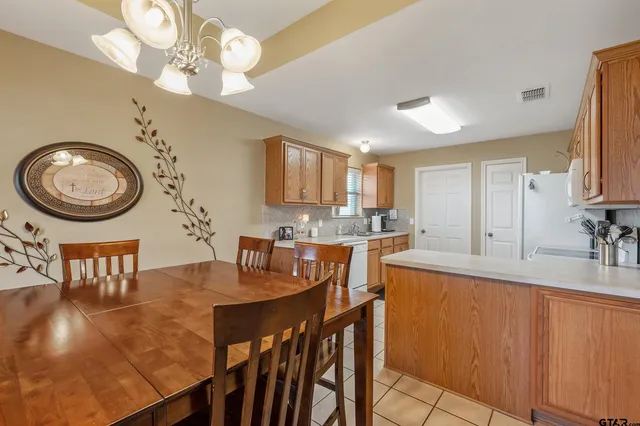 a view of a dining room with furniture and a chandelier