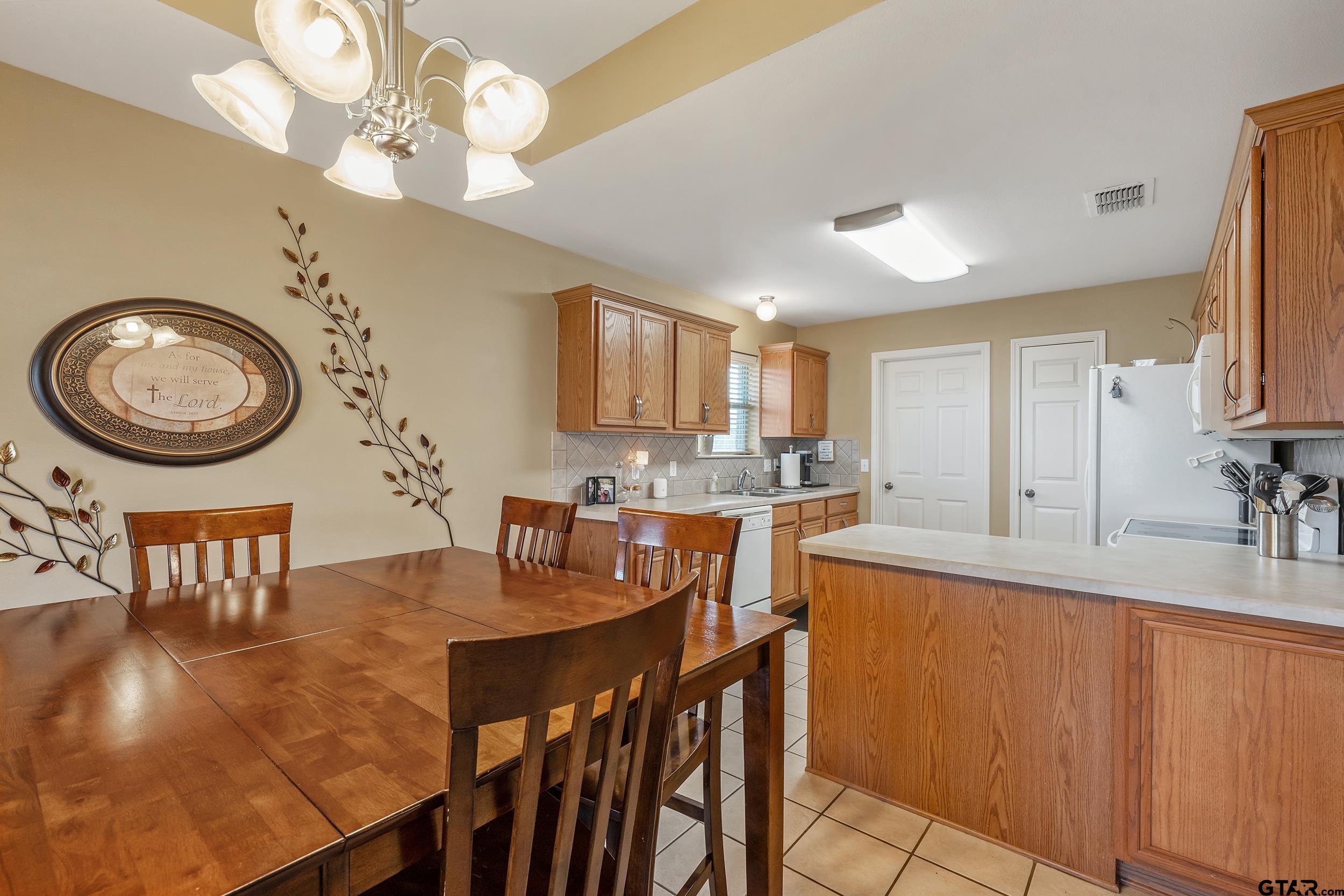 20081 Bluegrass Circle Flint, TX 75762 - Photo 10 of 24 a view of a dining room with furniture and a chandelier