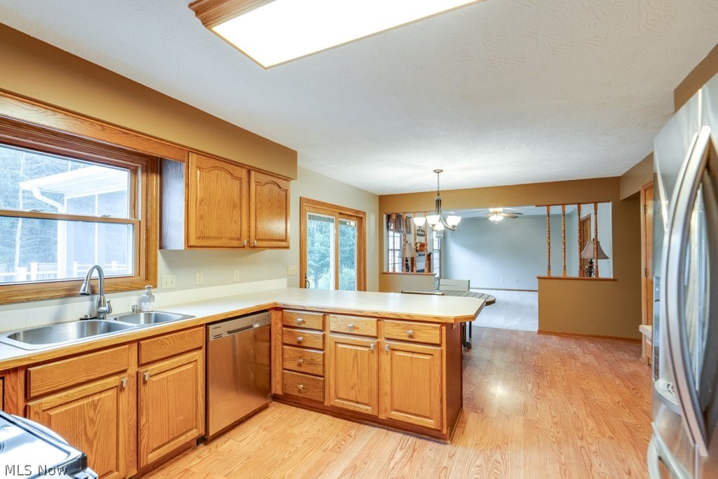826 Stewart Road Kent, OH 44240 - Photo 26 of 43 Kitchen featuring light wood-type flooring, sink, appliances with stainless steel finishes, and kitchen peninsula