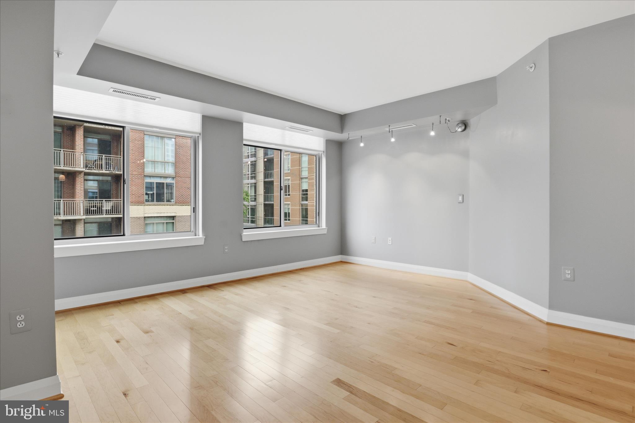 11990 Market Street, Unit 216 Reston, VA 20190 - Photo 25 of 41 a view of an empty room with a window and wooden floor