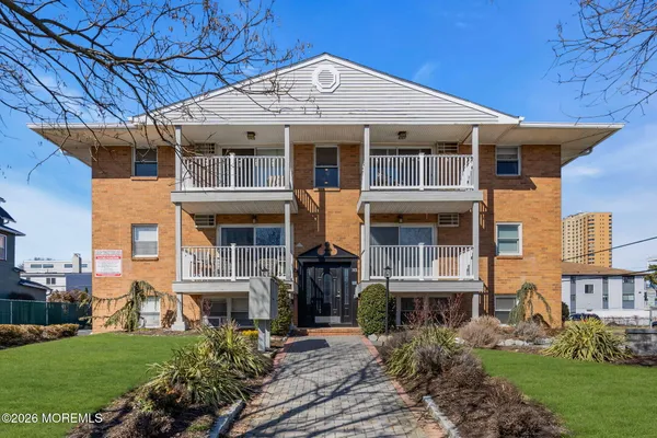 a front view of residential houses with yard