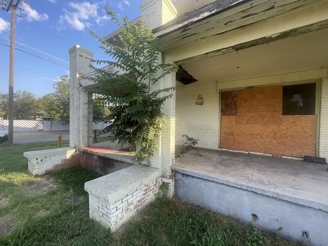 a backyard of a house with outdoor seating and plants