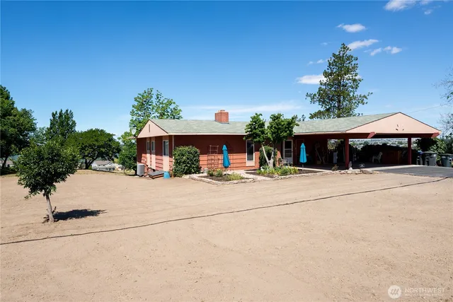 a table and chairs under an umbrella