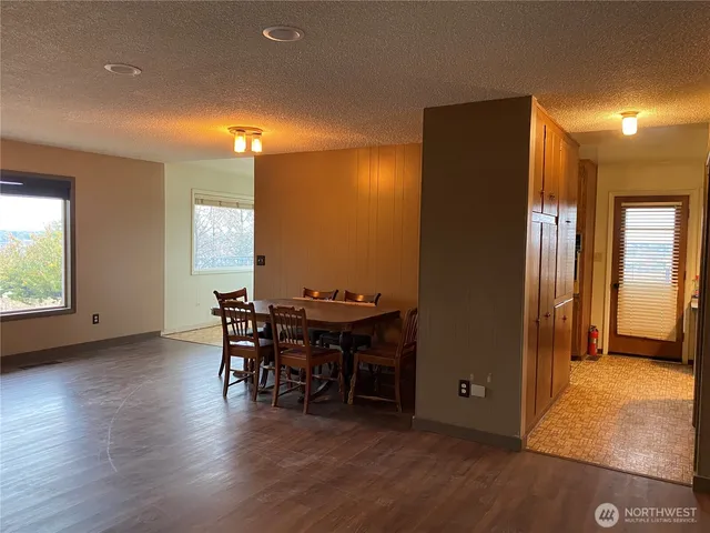 a room with a bed and wooden floor