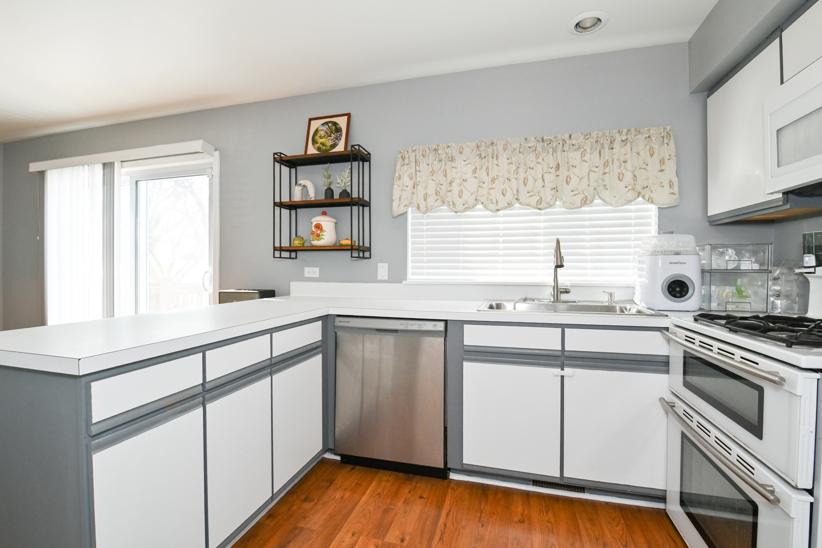 2092 Muirfield Circle Elgin, IL 60123 - Photo 11 of 14 a kitchen with granite countertop white cabinets and white appliances
