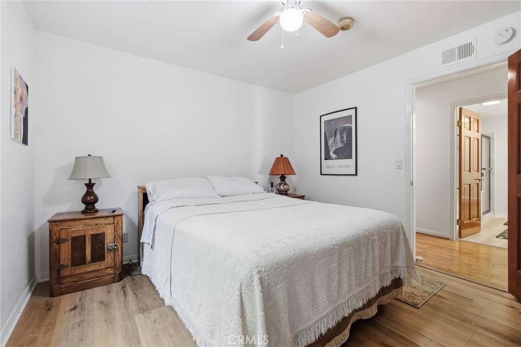 18233 Charlton Lane Porter Ranch, CA 91326 - Photo 11 of 40 a bedroom with a bed and a chandelier