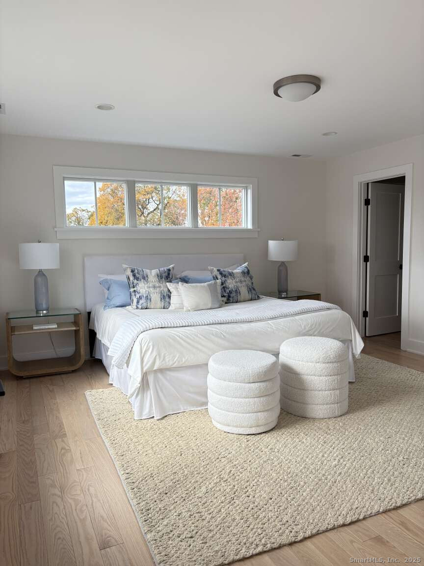 137 Millard Street Fairfield, CT 06824 - Photo 15 of 19 a bedroom with a bed and a large window