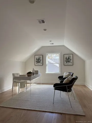 a living room with furniture and a piano table