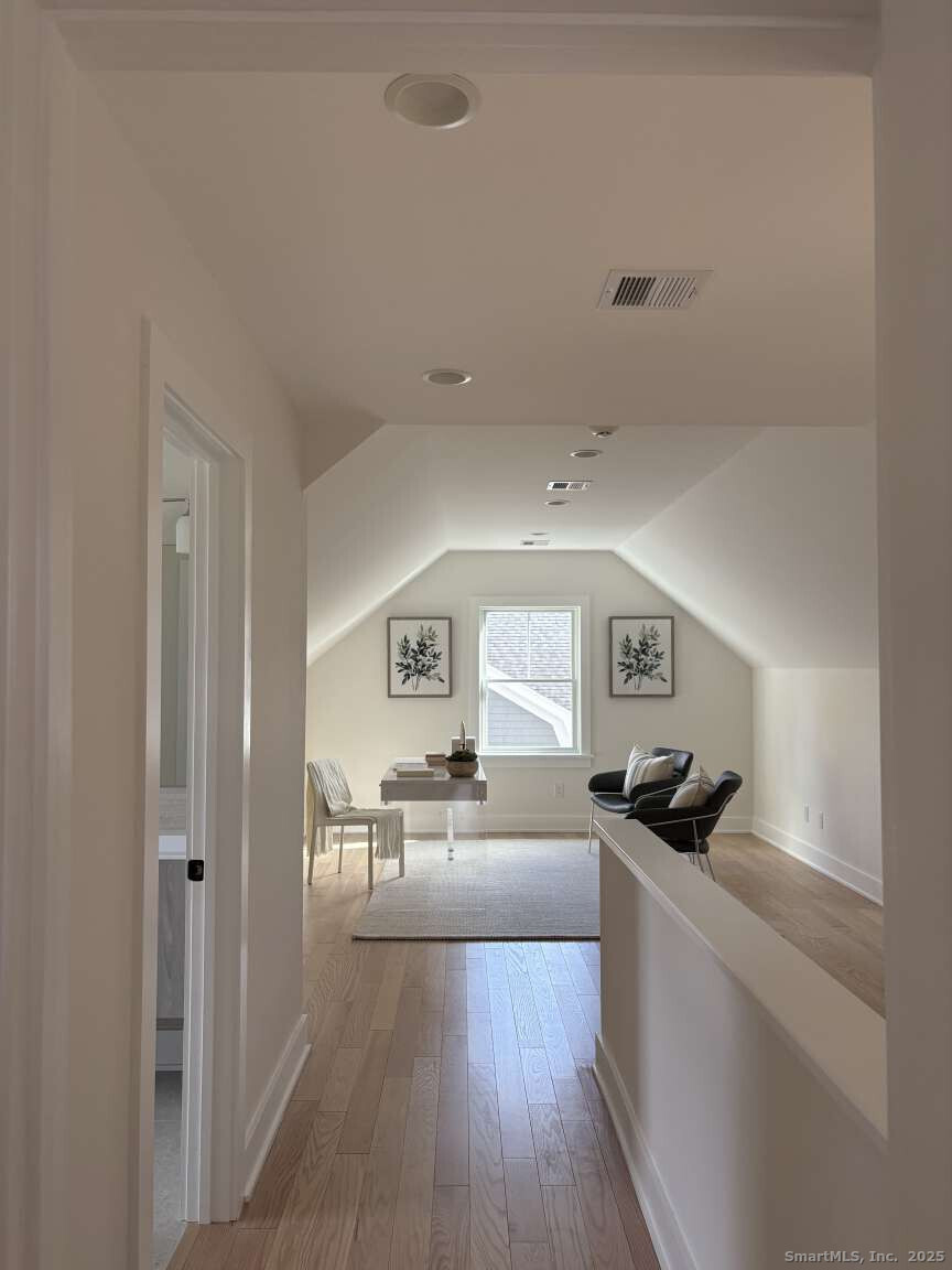 137 Millard Street Fairfield, CT 06824 - Photo 19 of 19 a living room with furniture and a wooden floor