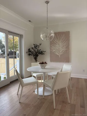 a view of a dining room with furniture window and wooden floor