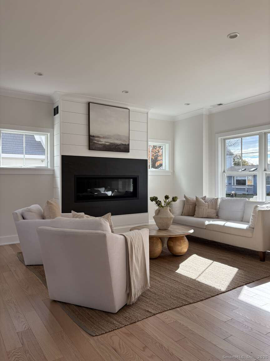 137 Millard Street Fairfield, CT 06824 - Photo 5 of 19 a living room with furniture and a fireplace