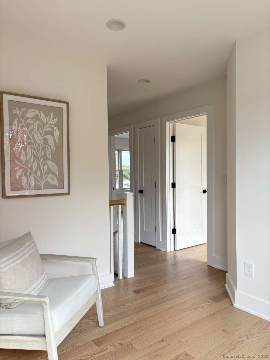 137 Millard Street Fairfield, CT 06824 - Photo 8 of 19 a view of livingroom with hardwood floor and hallway