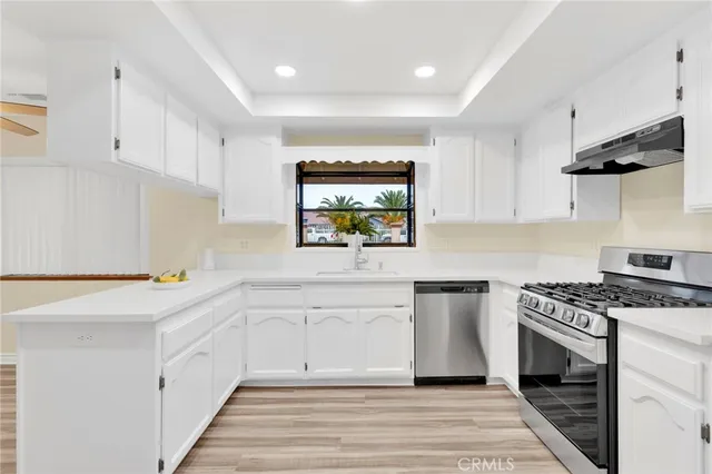 a kitchen with a stove a sink and a refrigerator