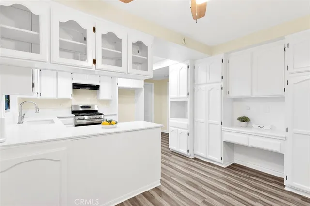 a kitchen with stainless steel appliances a stove a refrigerator and cabinets