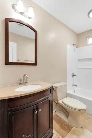 a bathroom with a toilet a sink and bathtub