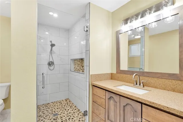 a bathroom with a sink a toilet and shower