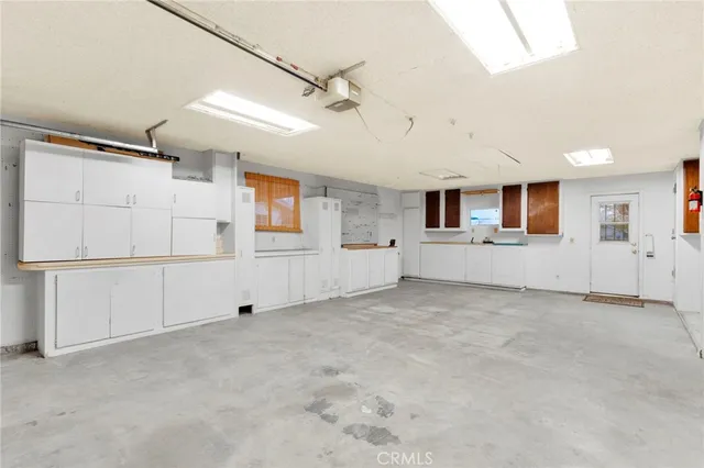 an empty room with an empty space and windows