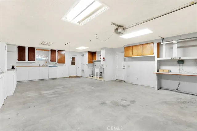 a view of a kitchen with a sink and cabinets