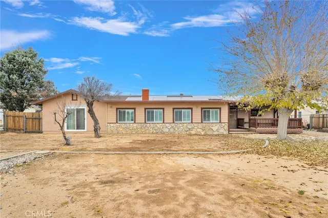 a view of a house with a wooden fence
