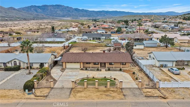 an aerial view of a house with garden space and a street view