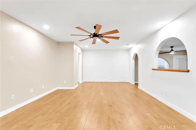 a view of a room with a ceiling fan and window