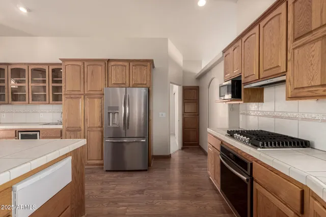 a kitchen with granite countertop a refrigerator and a sink