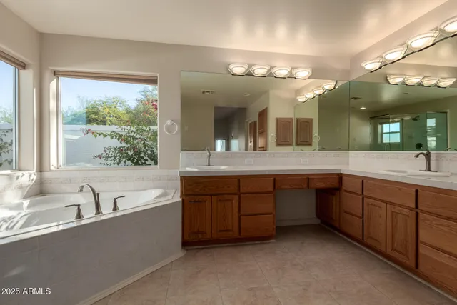 a bathroom with a large tub vanity and sink