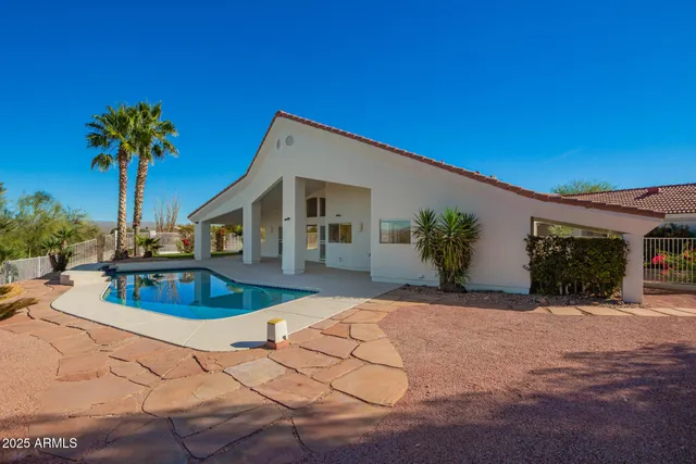 a view of a dining room with furniture a chandelier and wooden floor