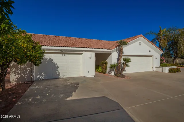 a view of a house with a yard and garage