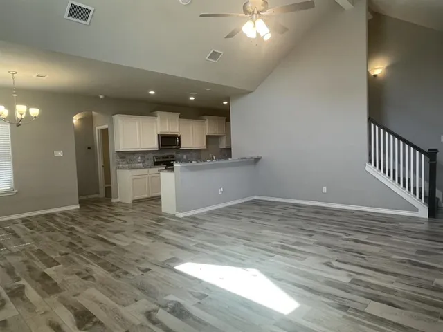 a view of a kitchen with a sink stainless steel appliances and cabinets