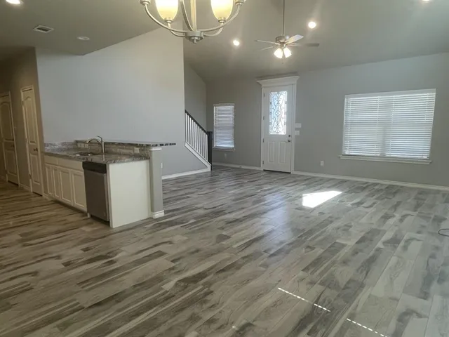 a view of entryway and hall with wooden floor