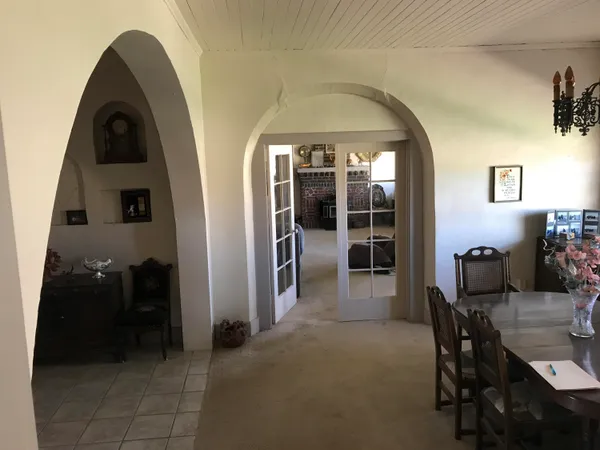 a bedroom with a bed couch and window