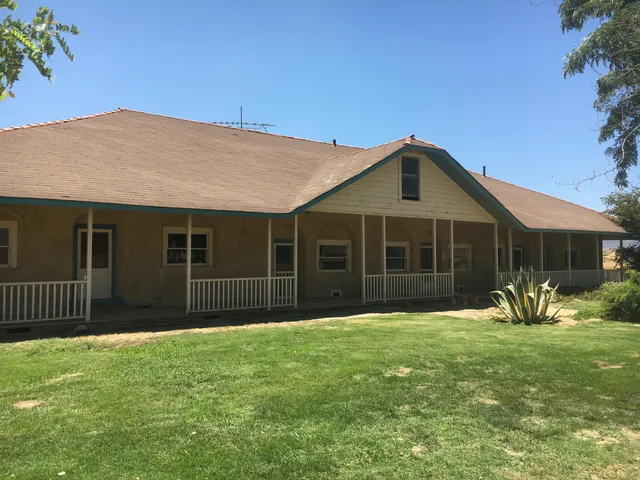 a front view of house with yard outdoor seating and barbeque oven