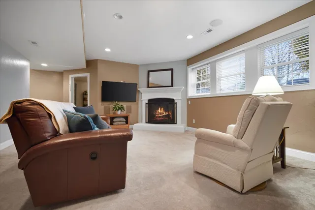 a living room with furniture flat screen tv and a fireplace